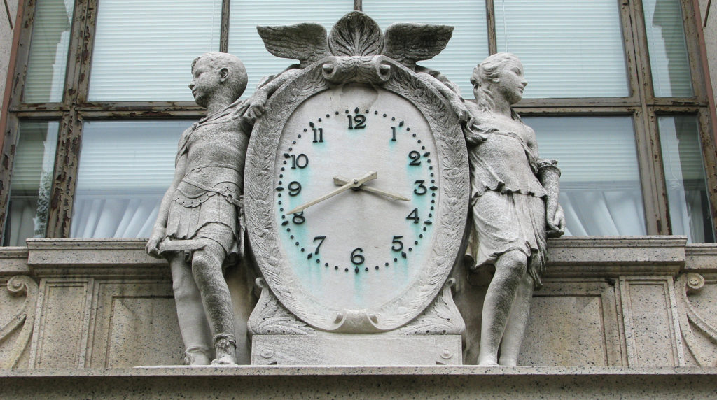 stone clock over the entrance to the Bank Of America in downtown Greenwich, CT